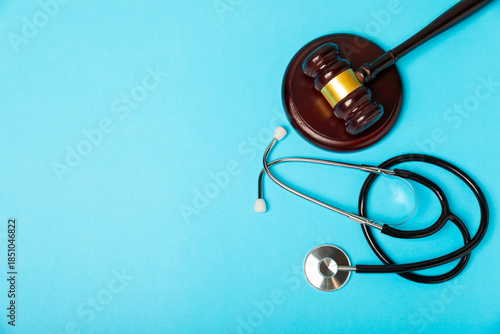 A stethoscope and hammer on a desk. Medical malpractice, personal injury lawyer, and healthcare legal aspects concept.Lawyer.Legal definition of medical negligence. Law concept.Healthcare and Medicine
