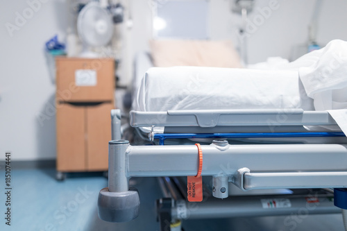 Shallow focus of the edge of a hospital bed seen in a typical NHS hospital in Britain. The room is a private room off the main ward.