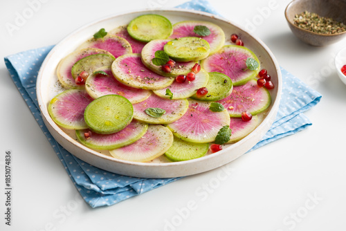 Close  up of sliced winter pink radishes on plate