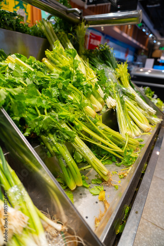 Fresh organic green asparagus and raw vegetables displayed at a spring market offer healthy natural ingredients for vegetarian cooking and a nutritious diet