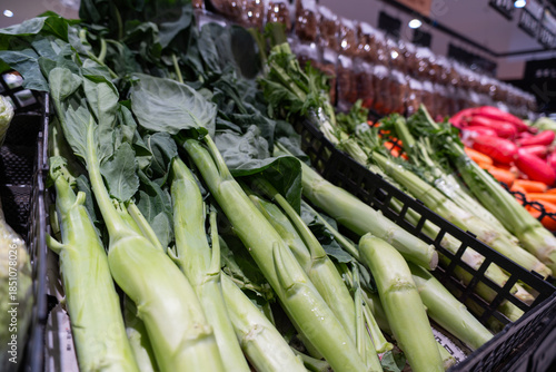 Fresh organic vegetables and tropical fruits like corn and bananas are for sale at a natural farm market stall featuring healthy raw produce