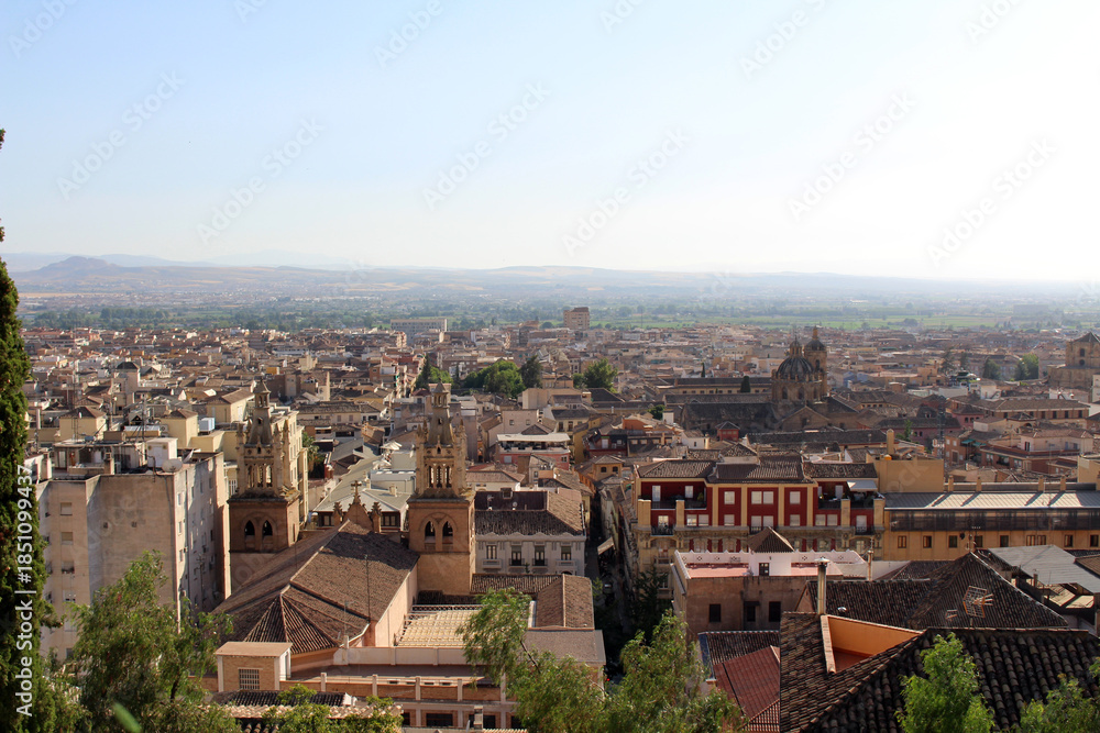 Obraz premium Hilltop view of Granada with church towers, cathedral, basilicas, and historic skyline, photographed in July 2024.