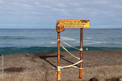 Sign warning of the dangers of the sea, such as huge waves, Puerto de la Cruz, Tenerife, Canary Islands, Spain