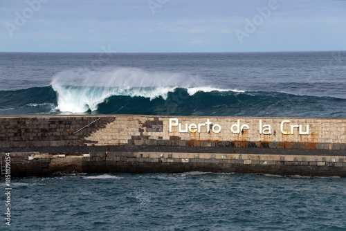Pier of Puerto de la Cruz in front of large wave (Tenerife, Canary Islands, Spain)