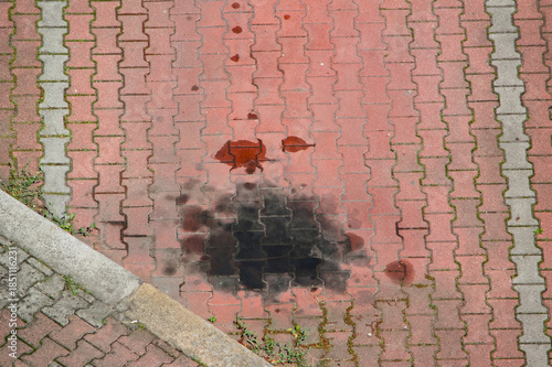 Oil stain with on empty cobblestone parking space