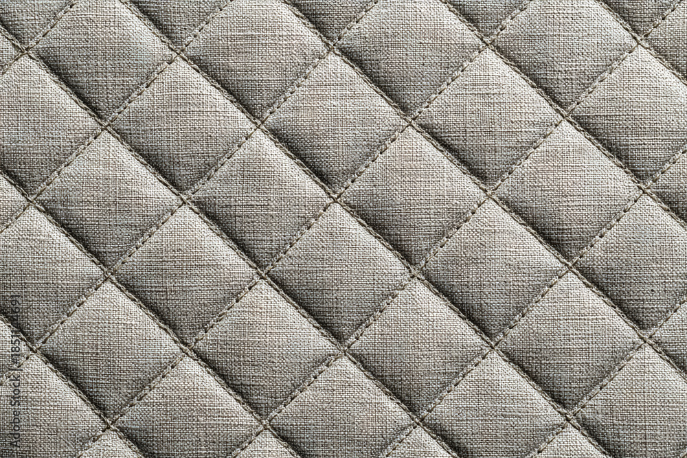 Fototapeta premium neutral background of diamond quilted fabric