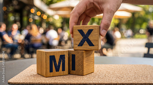 Hand arranging MIX with wooden blocks embodying strategic business choices creative solutions and diverse ideas for cafe