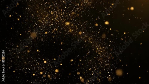 Golden Glittering Particles Falling on a Dark Background with Bokeh Effect.