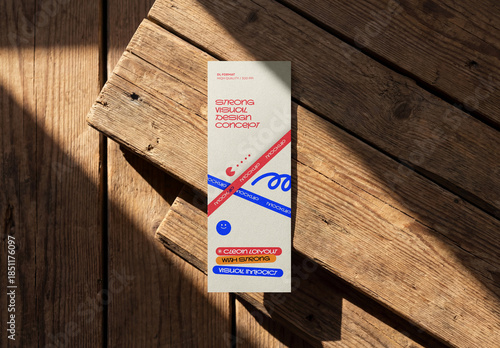 Template Mockup Vertical Flyer Branding Design on Wooden Surface with Natural Sunlight