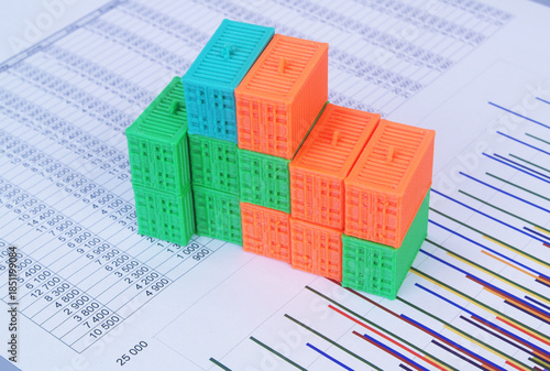 Many containers on financial reports. Cargo and logistics concept.
