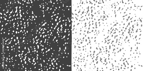 Abstract black and white texture with scattered speckles and a vertical split