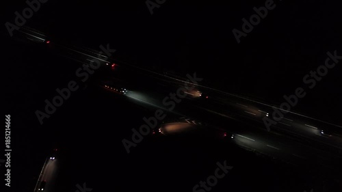 Aerial Night View of Moving Cars with Light Trails on Highway Interchange