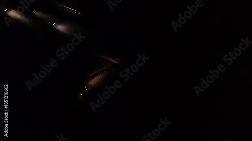 Aerial Night View of Moving Cars with Light Trails on Highway Interchange