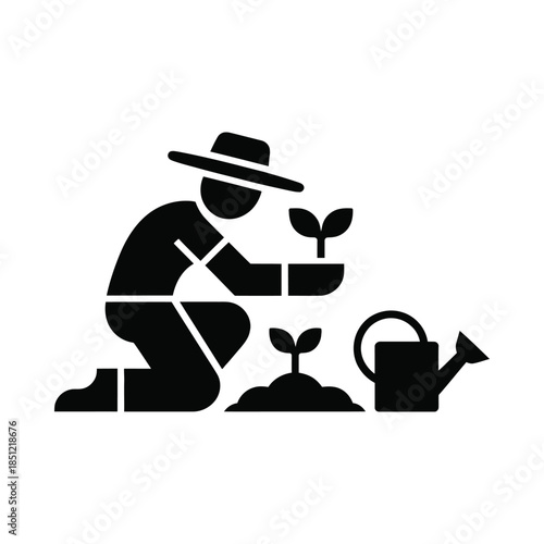 Gardener planting seedling with watering can