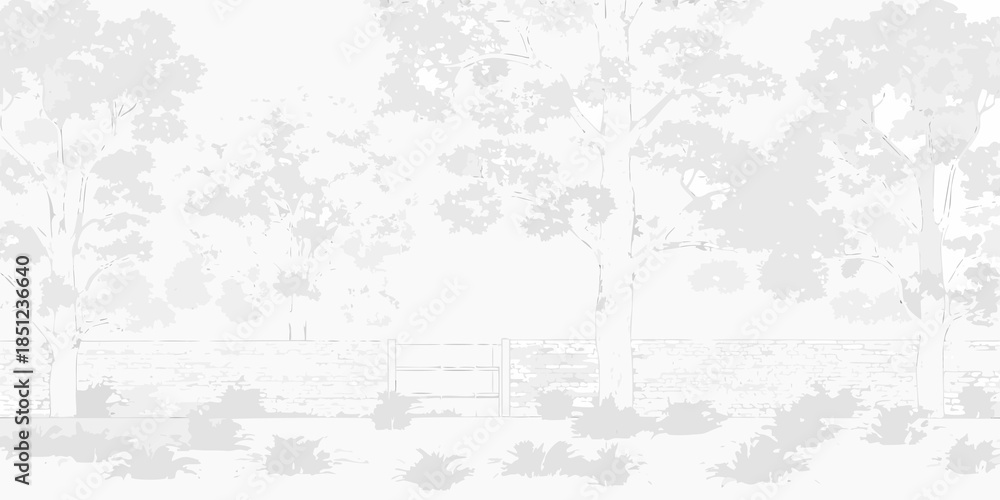 Fototapeta premium A grayscale view of trees and a low stone wall in a park setting