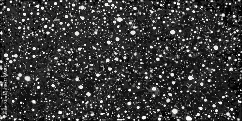 A dark background with scattered bright irregular shaped white spots