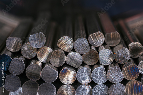 Nonferrous metal rods stacked together showing texture and reflections