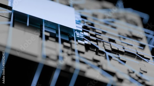 Close-up view of a metal grid with white rectangular objects attached, against a blurred dark background with a shallow depth of field.