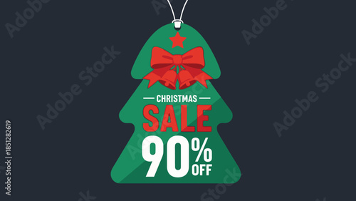 A green Christmas tree shaped sale label with a red bow hanging against a dark background