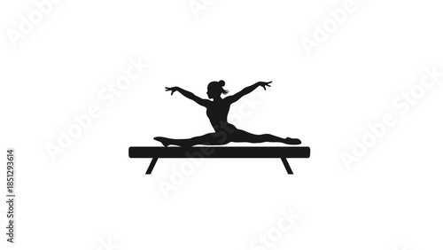 Silhouette of gymnast performing split on balance beam