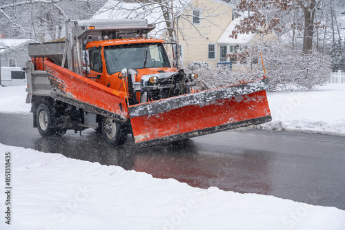 Photography snowplow driving on residential street