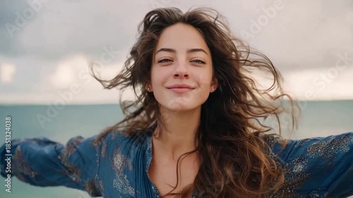 Embracing Freedom: A woman with flowing hair, arms outstretched, breathes in the fresh sea air, radiating a sense of unbound freedom and joy.