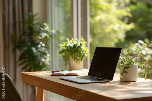Wallpaper Mural Workspace with laptop, notepad, and plants in a sunlit room during afternoon hours Torontodigital.ca