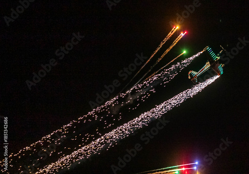 fireworks launched from an airplane at an airshow