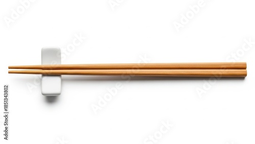 Elegant bamboo chopsticks on ceramic holder.