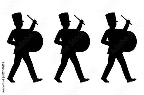 Silhouette of three marching band drummers in uniform carrying bass drums ready for parade