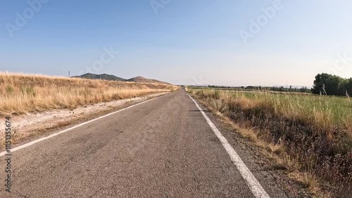 paved road through agricultural fields between the train station of Caminreal and Fuentes Claras, province of Teruel, Aragon, Spain