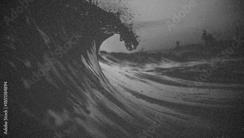 Black and white photo of surfing wave with grunge texture.