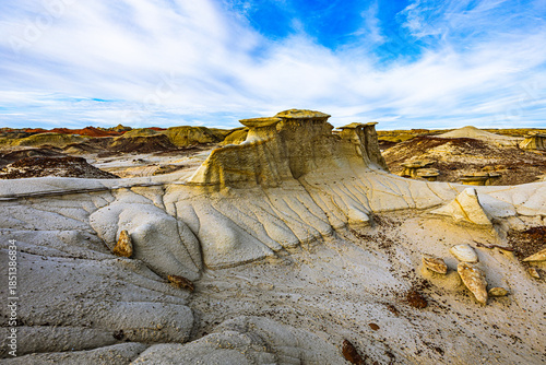 Canvas Print Unique hoodoos and eroded rock layers stand beneath a vivid blue sky in the Bisti Badlands
