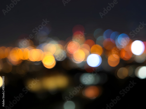 Abstract city lights bokeh at night with colorful glowing orbs, modern urban background expressing energy, nightlife atmosphere, and contemporary metropolitan mood

