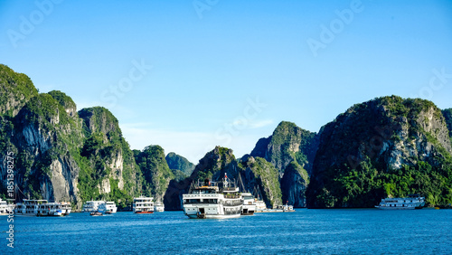 Cruise ships navigate the karst landscape of Ha Long Bay, Vietnam