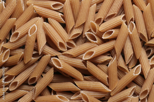 Photos Penne pastas whole-grain close up studio shot over