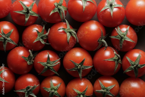 Cherry tomatoes with water drops close up studio shot over