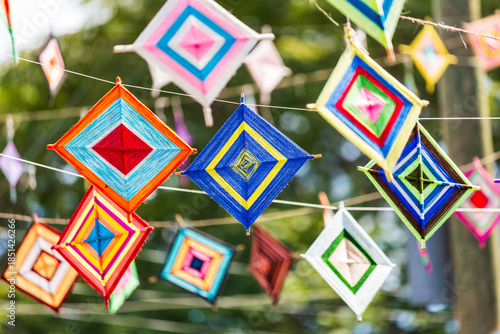 North America, Mexico, Nayarit, Bahia de Banderas, Nuevo Vallarta. Colorful hangings over street. They are called Ojos de Dios (God's eyes), a traditional Mexican and Native American craft.