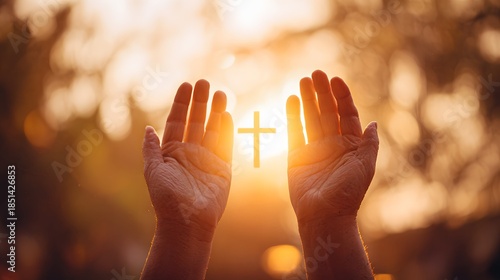 Hands reaching towards a cross in the sunlight, faith and hope.