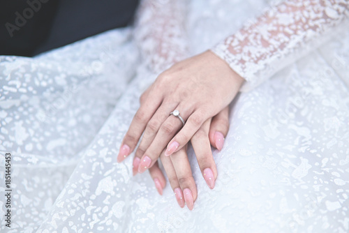 hands of bride wearing wedding ring in ring finger for Valentine's day concept