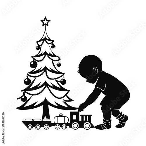 Child playing with train under christmas tree