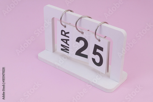 March 25 on calendar on pink background	