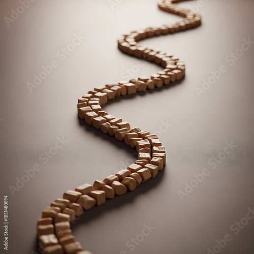 Winding pathway crafted from small wooden blocks on a smooth surface