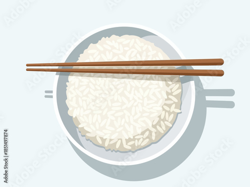 A bowl of steaming white rice viewed from directly above with chopsticks resting on the edge