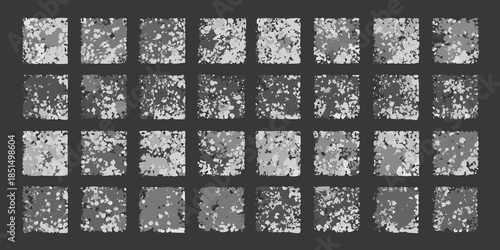 Abstract grid of speckled monochrome squares on a dark background