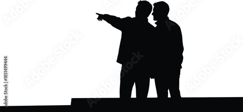 Black silhouette of two men standing together one pointing forward suggesting direction teamwork future
