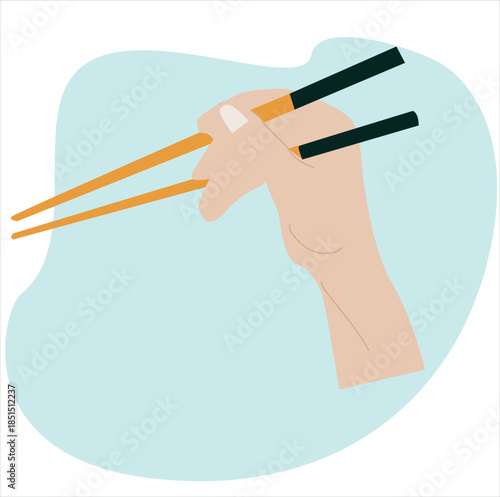 hands holding chopsticks. Hand is skillfully manipulating a pair of chopsticks, 
