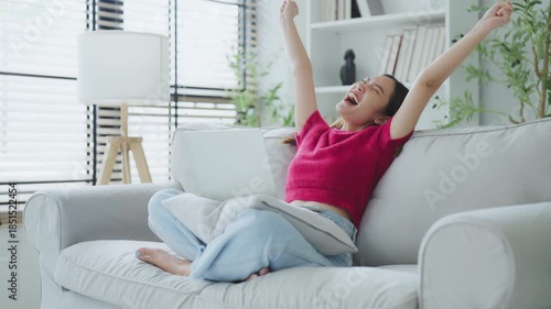 Happy euphoric young asian woman celebrating winning or getting ecommerce shopping offer on computer laptop. Excited happy girl winner looking at notebook celebrating success