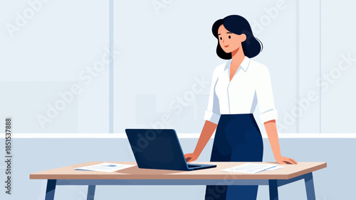 A woman is sitting at a desk with a laptop in front of her. She is smiling and she is enjoying her work