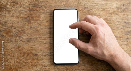 Overhead view of hand pinching to zoom on smartphone screen